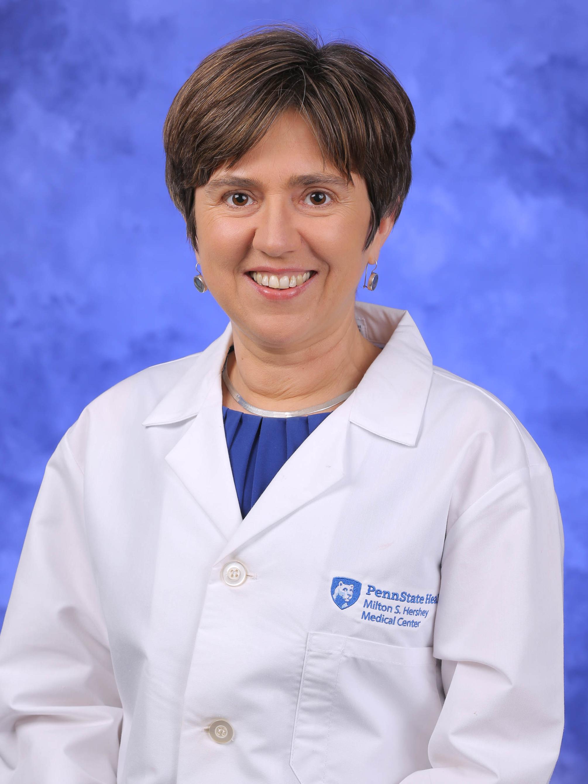 Dr. Aleksandra Zgierska poses for a professional headshot, wearing a physician's coat.
