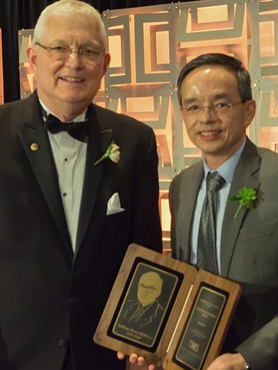 Zi-Kui Liu receiving the William Hume-Rothery Award from David DeYoung.