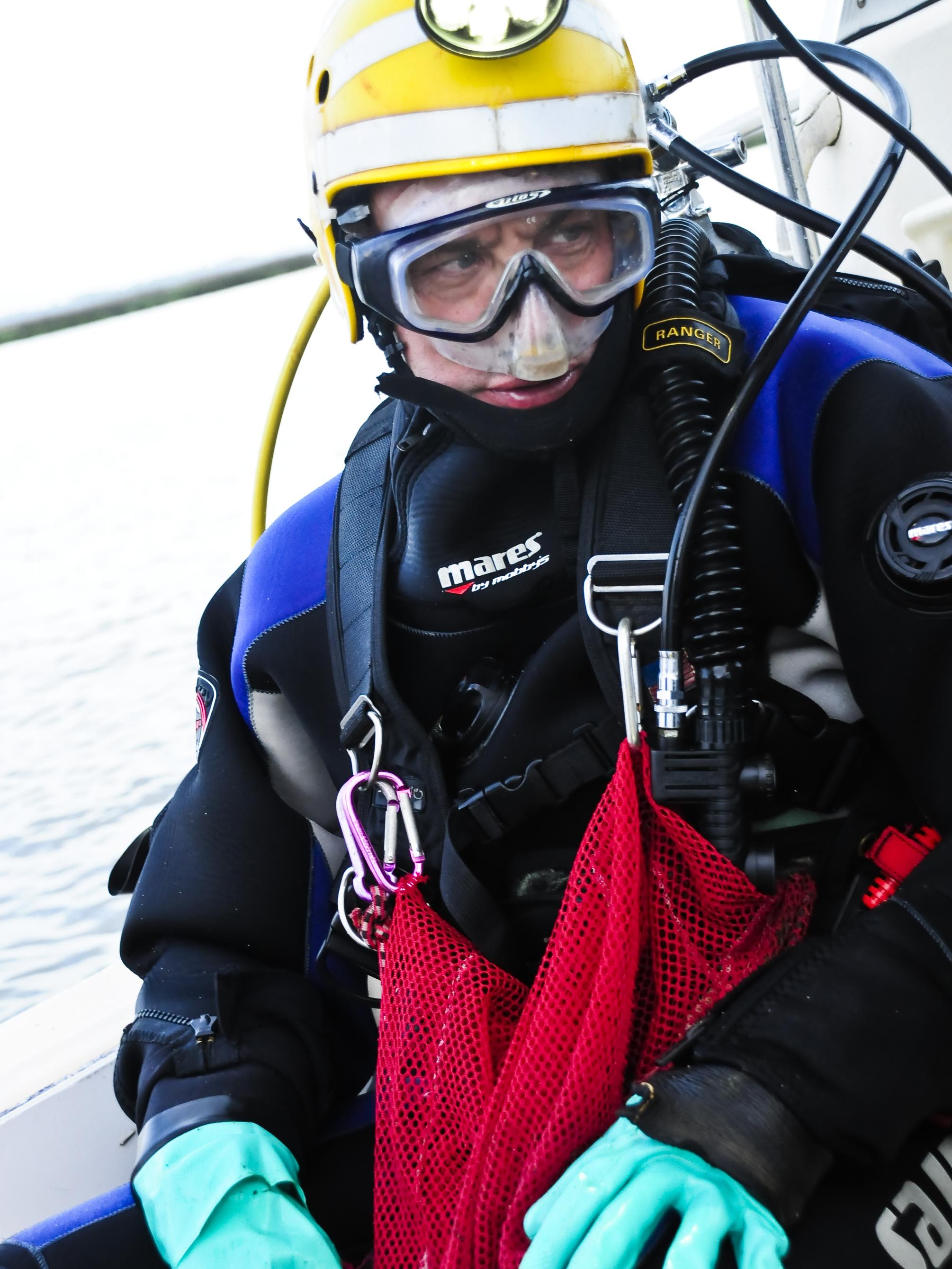 Scuba diver Bill Eberlein prepares to enter the water.