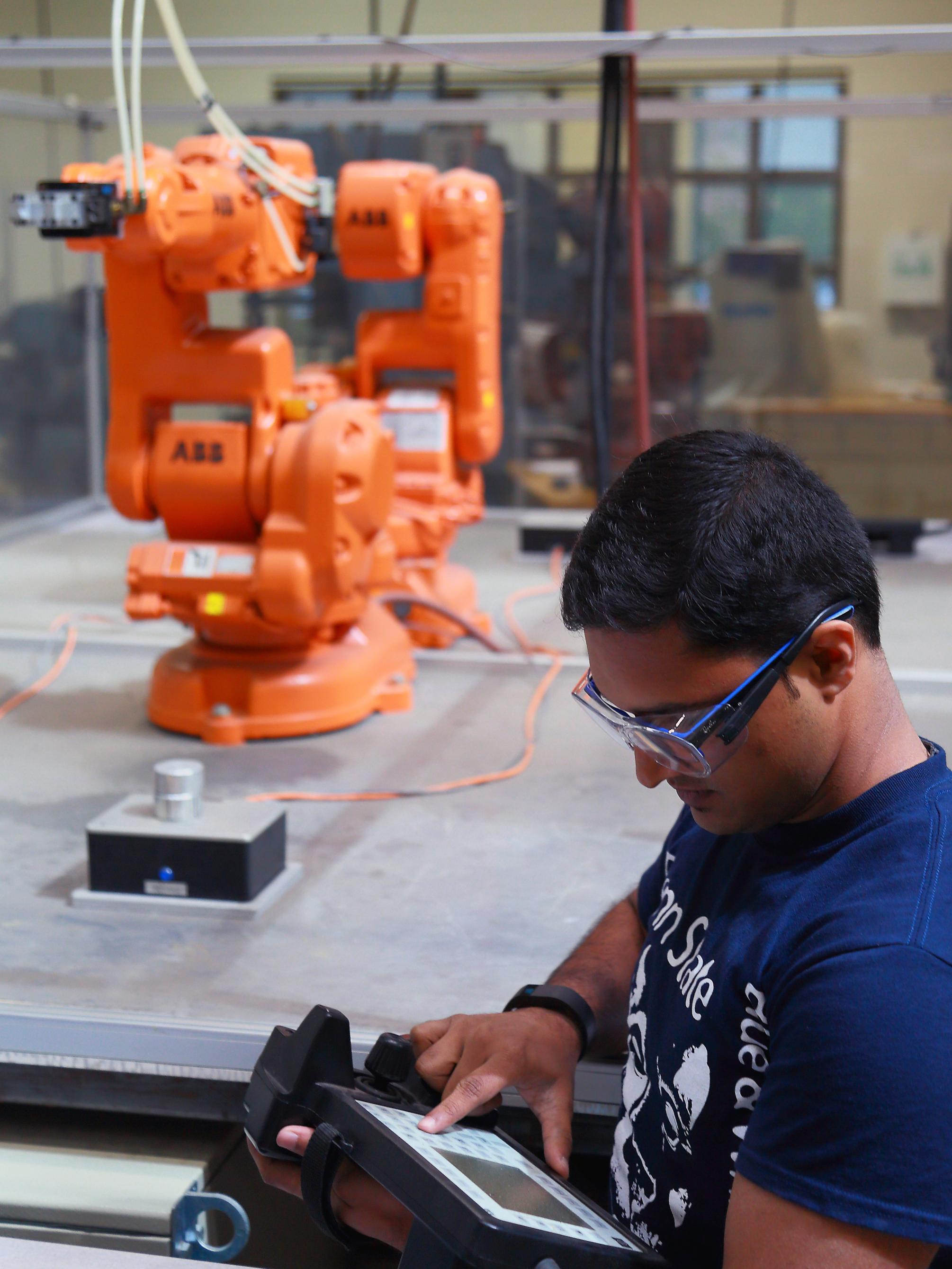 Badarinath works with an ABB robot in the Factory for Advanced Manufacturing Education. 