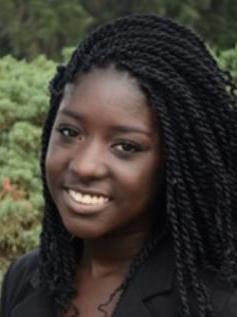 Abenna Jones headshot smiling with long black hair.