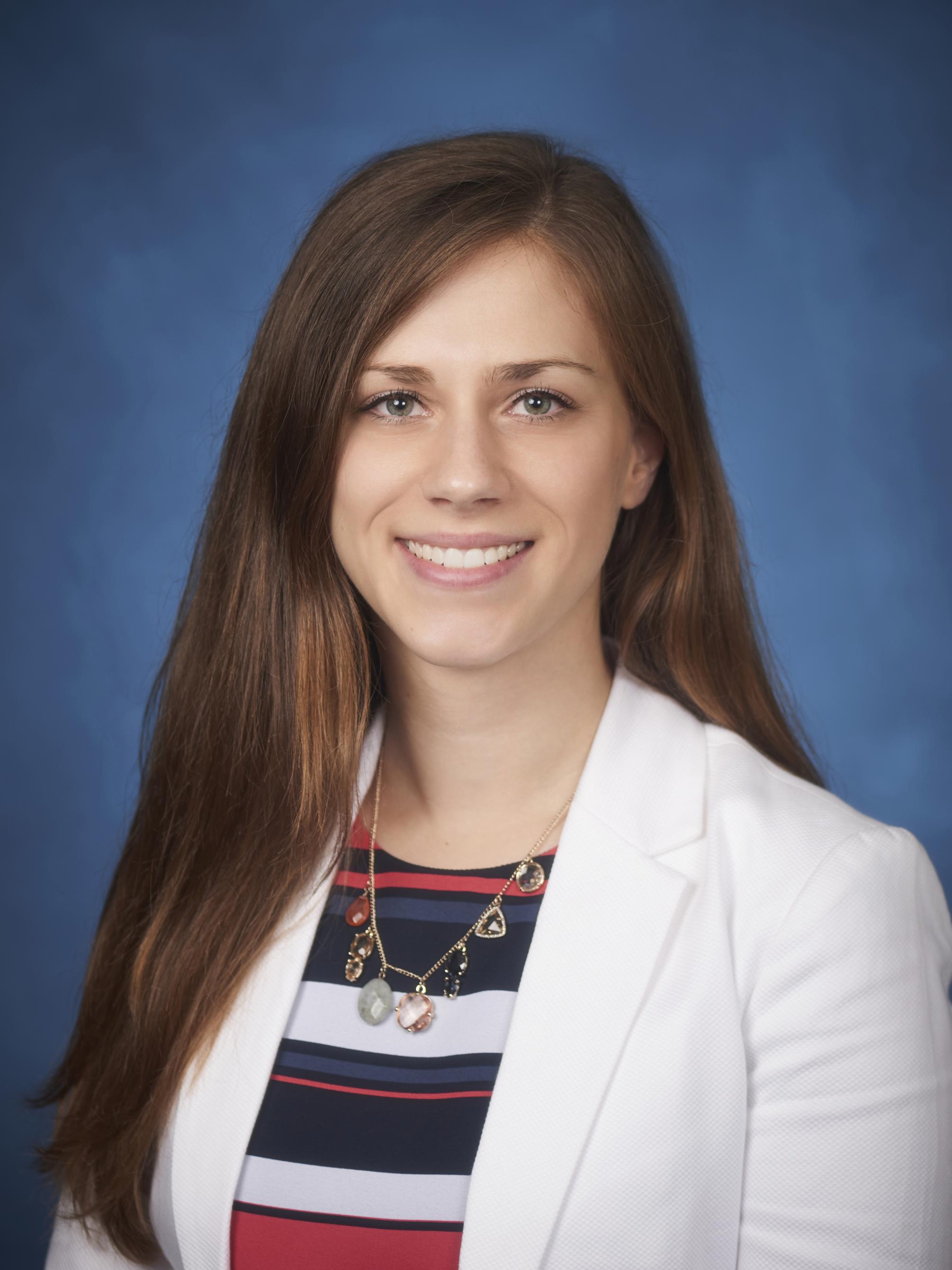 photo portrait of woman with long hair wearing white blazer and striped shirt