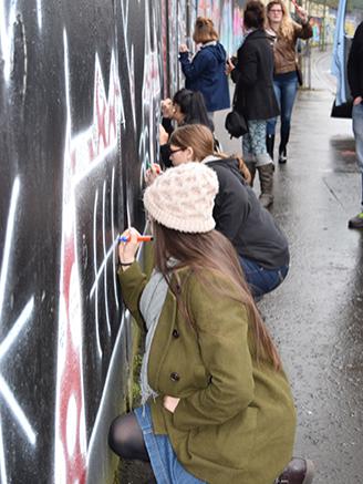 students signing peace wall