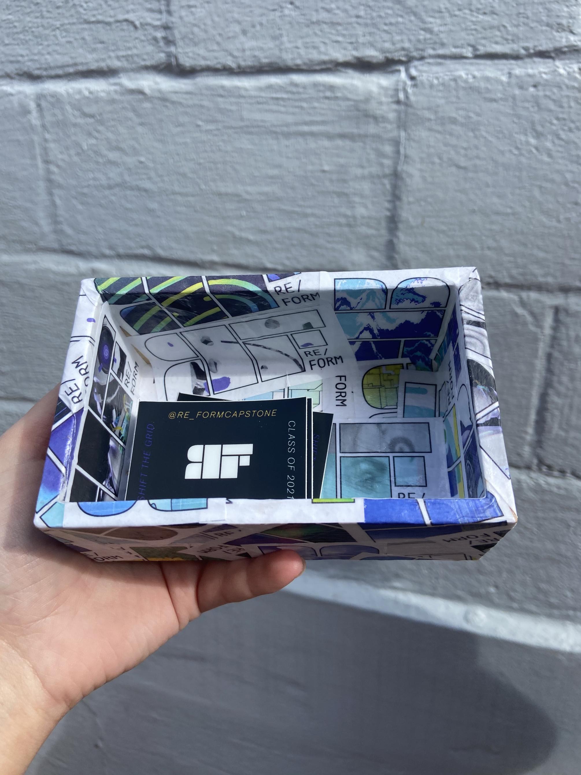 A box containing stickers that the students designed to promote “Re/form.” 