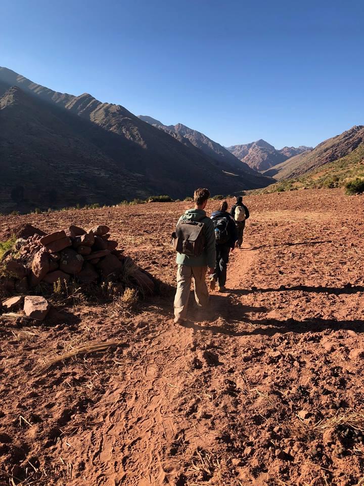 Students hiking along dirt path.