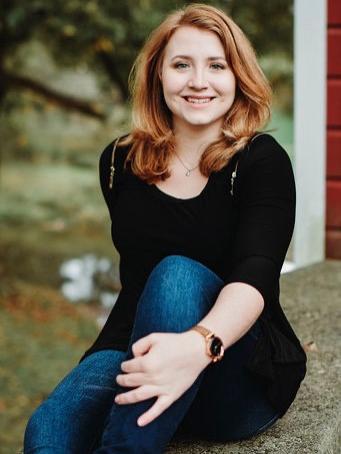 female student sitting outside