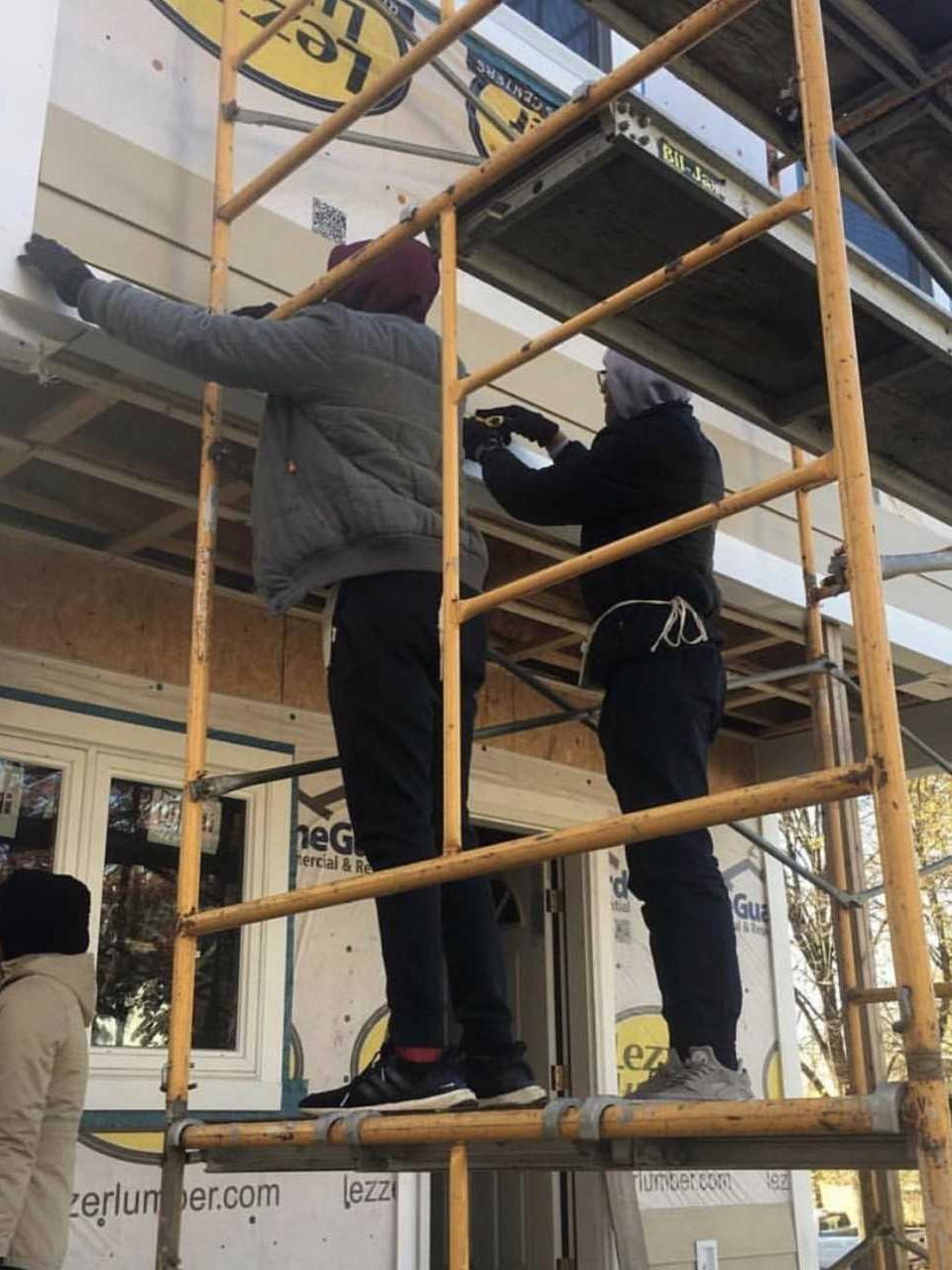 students standing on scaffolding