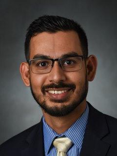 A headshot of a smiling professor.