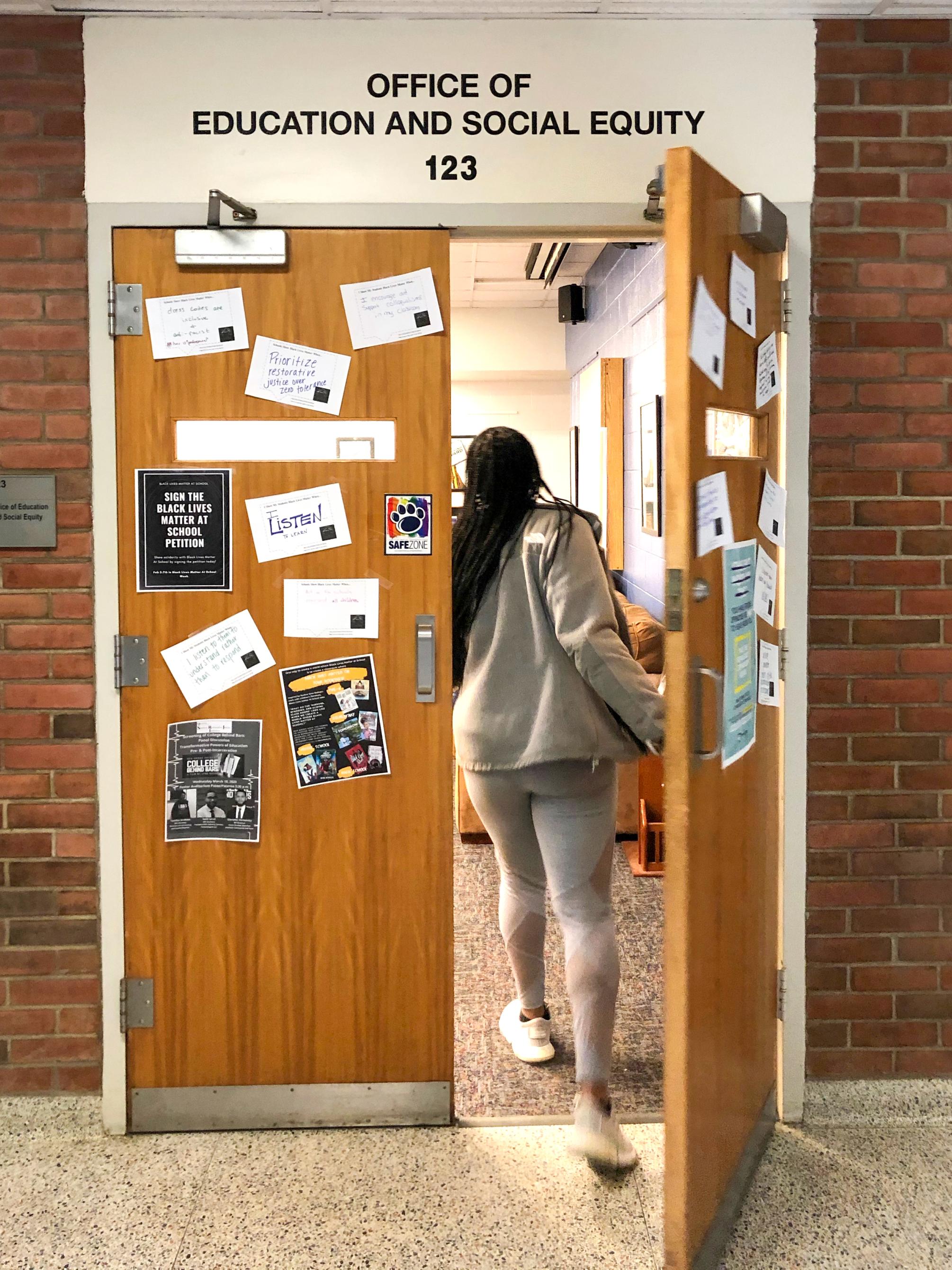 Student walking into Office of Eduation and Social Equity