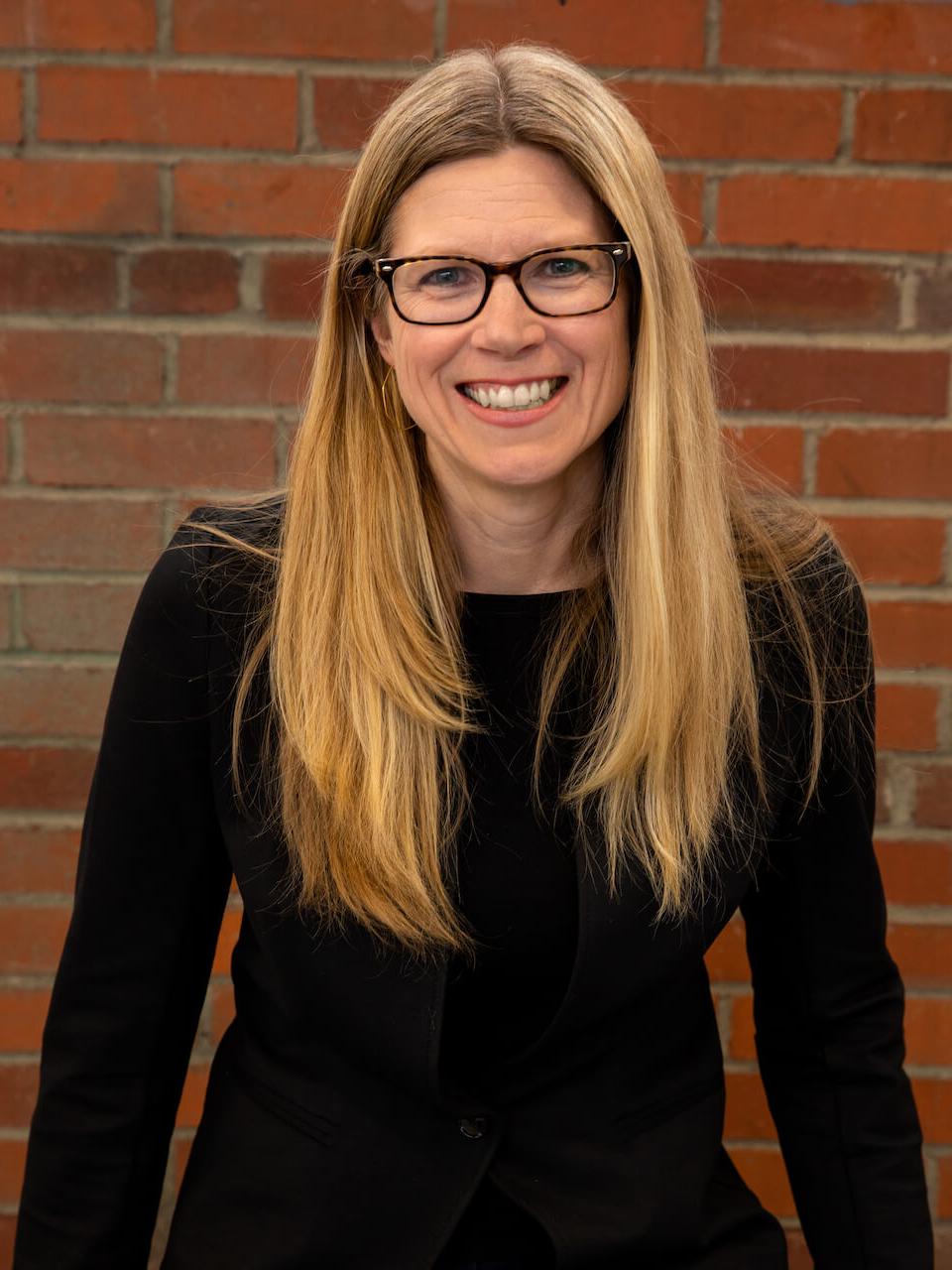 head shot of woman in glasses