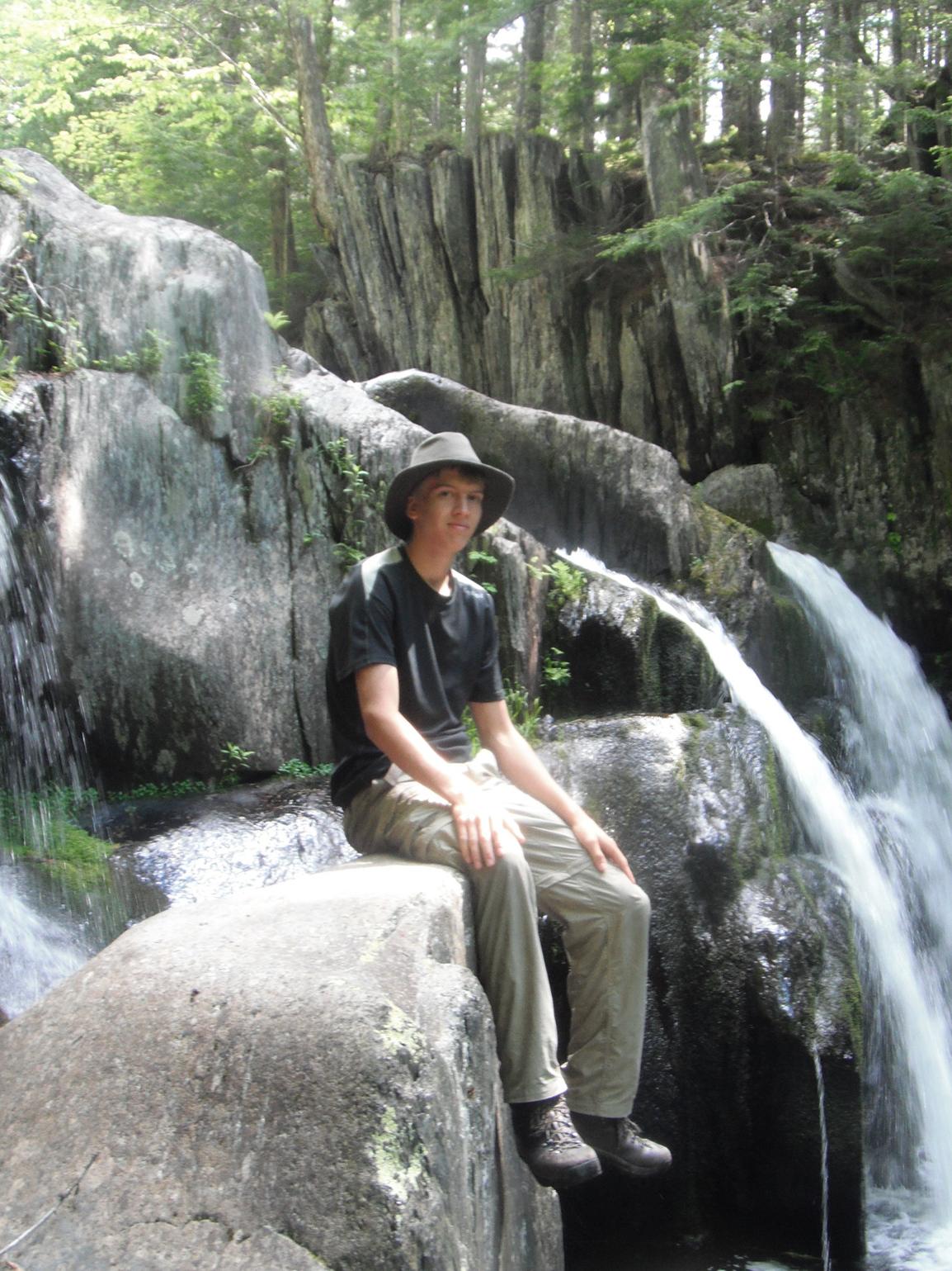 Kyle Johnson next to waterfall