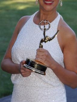 Woman holding an Emmy award