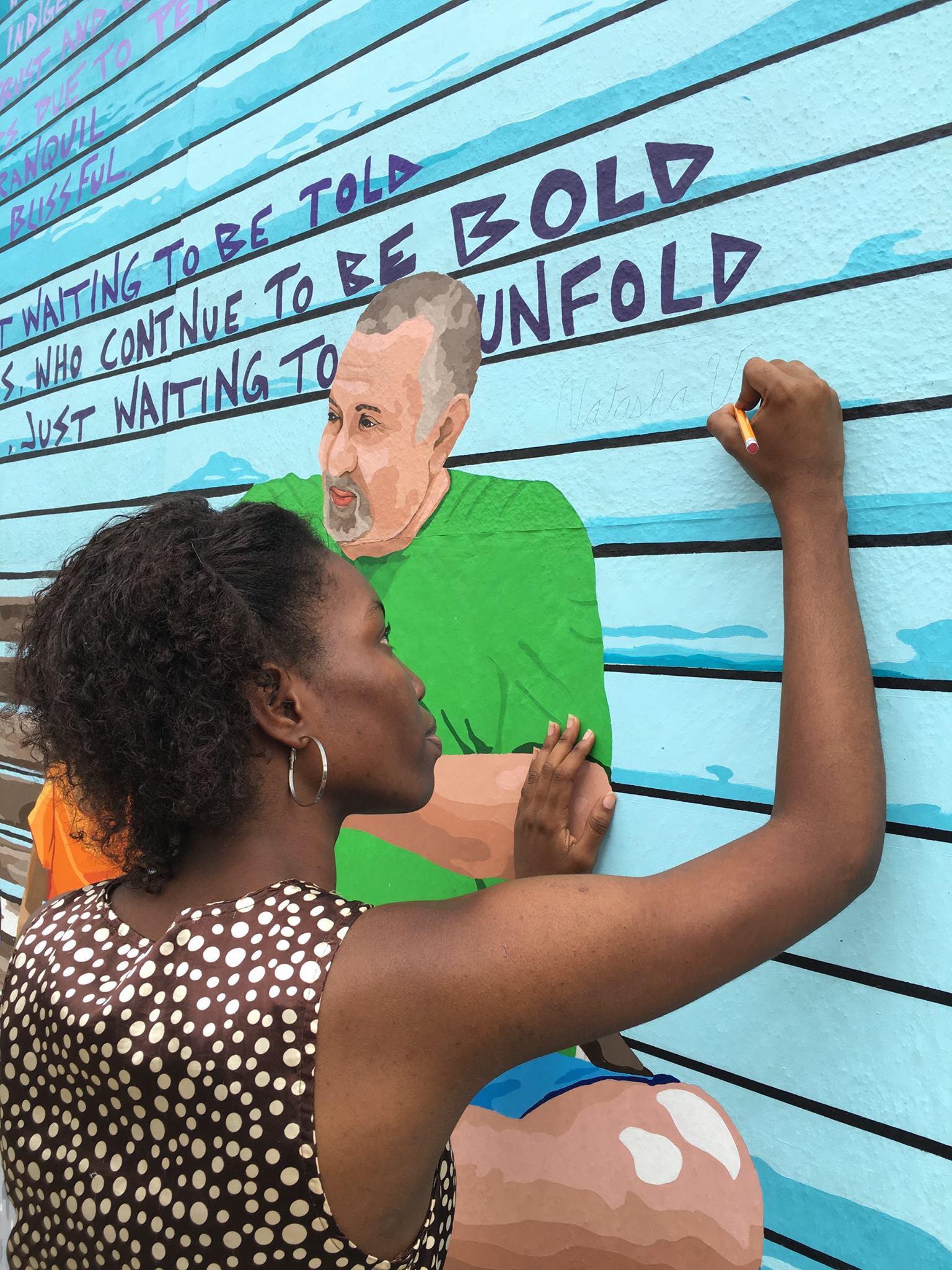 Natasha Velasquez works on a mural in San Ignacio, Belize