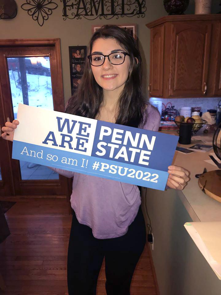 Penn State Schuylkill's Lily Stoyer holds a "We Are" sign.