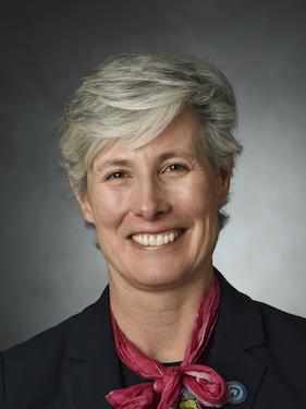 A head and shoulders photo of a woman smiling. 