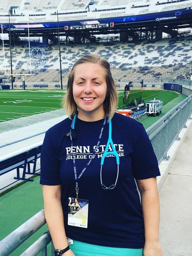 Sarayna Schock stands in the foreground, with the field and bleachers of Beaver Stadium in the background.