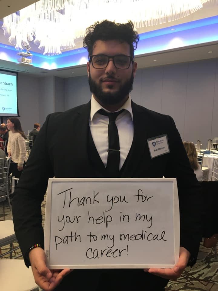 student holding marker board