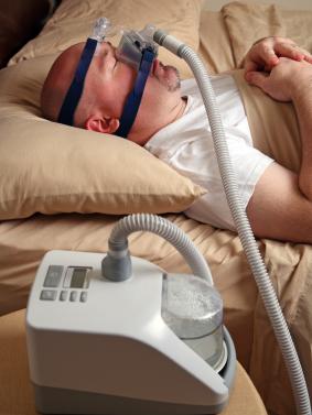sleeping man with CPAP mask