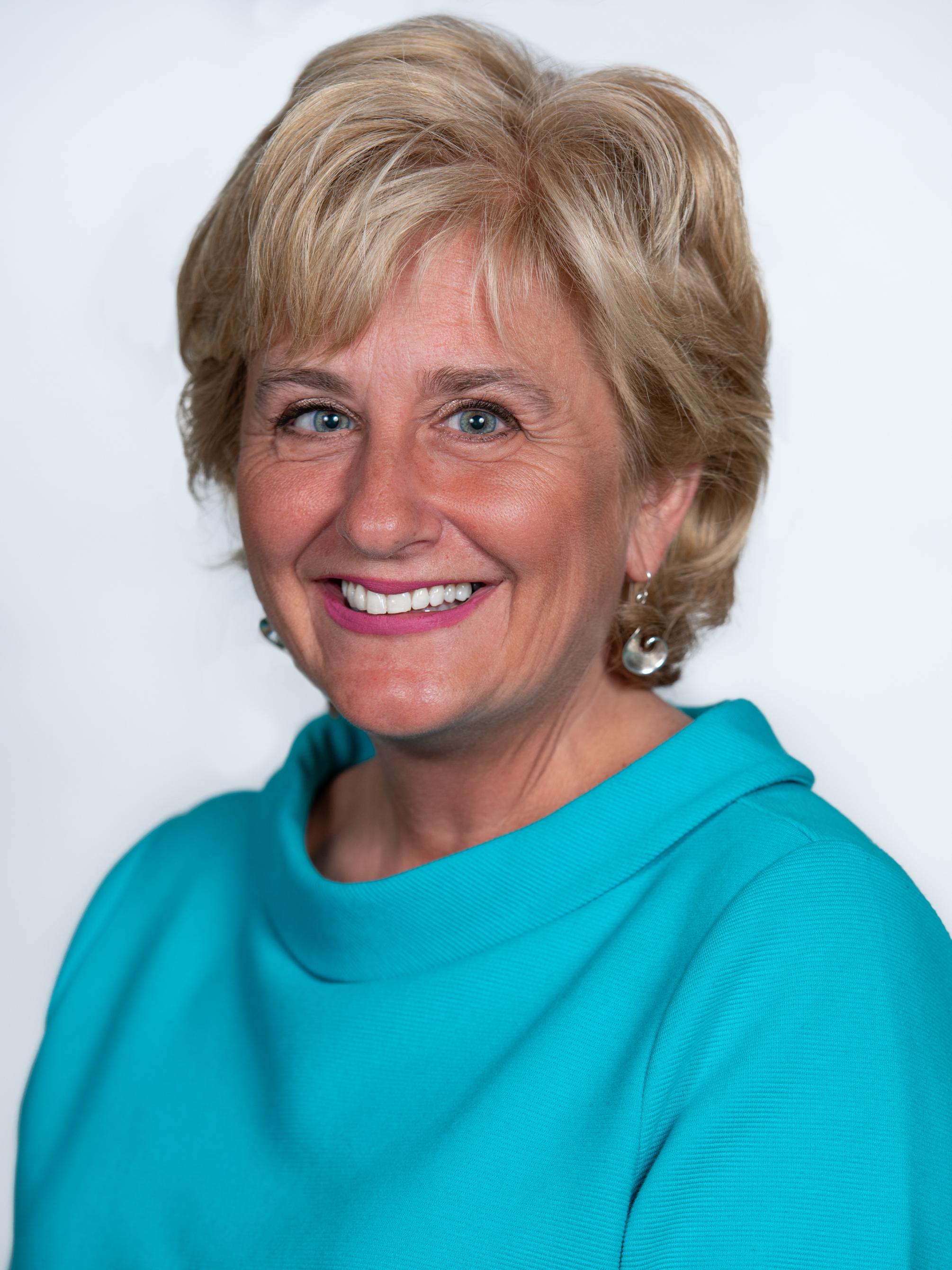 headshot of a woman in turquoise top