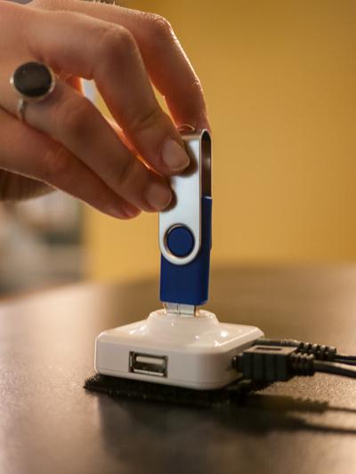 A participant engages the thumbdrive 