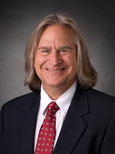 man smiles for portrait style photograph