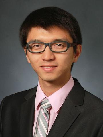 male smiles and poses for professional headshot