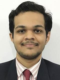 male student in business attire poses for professional headshot photo