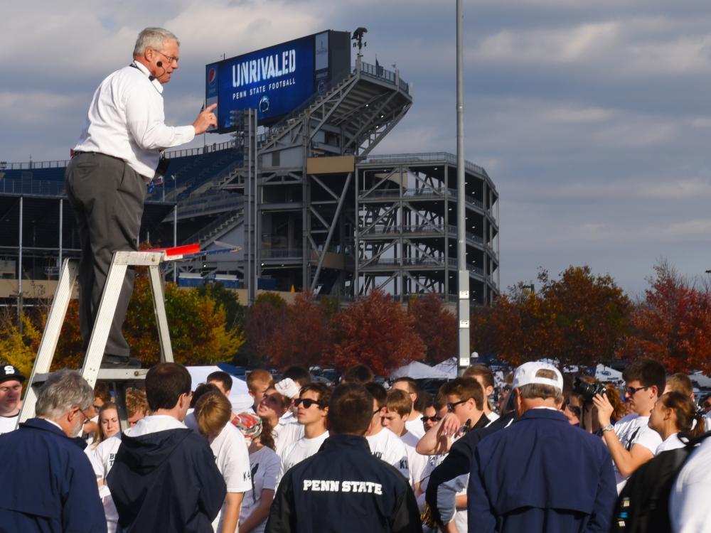 The Penn State Blue Band director addresses members of the marching band at the end of practice.