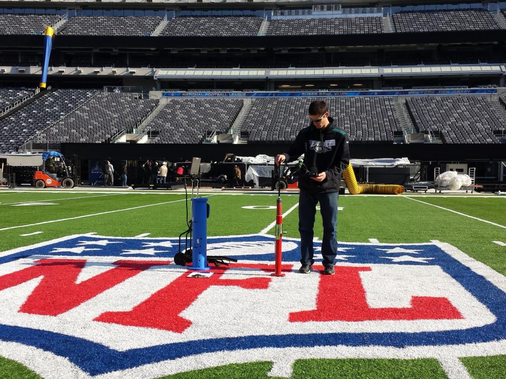 Penn State alumnus performs surface hardness test on NFL football field