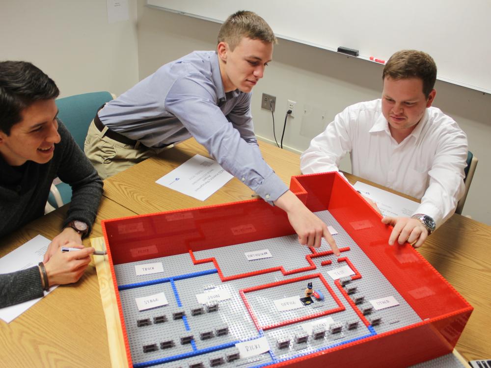 Sergio Viscarra, Jabel Warren and Steven Prigg present their team’s LEGO model of the proposed floor layout to the ENCS inventory team at a status meeting this semester. 