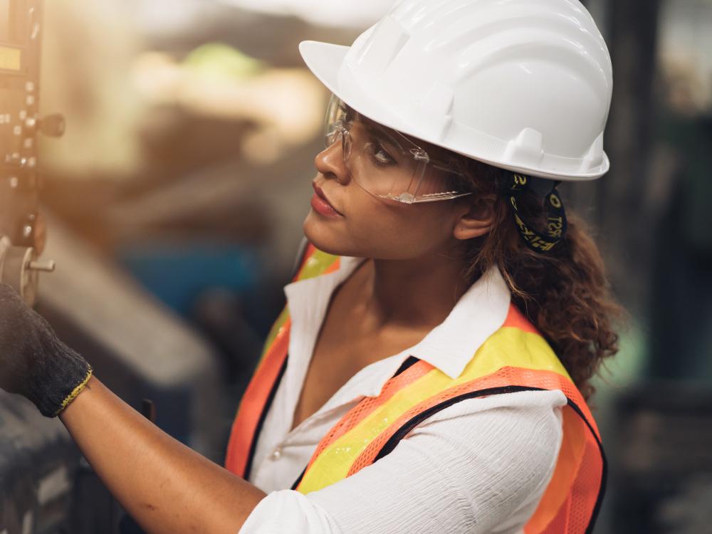 Woman wearing hard hat on shop floor