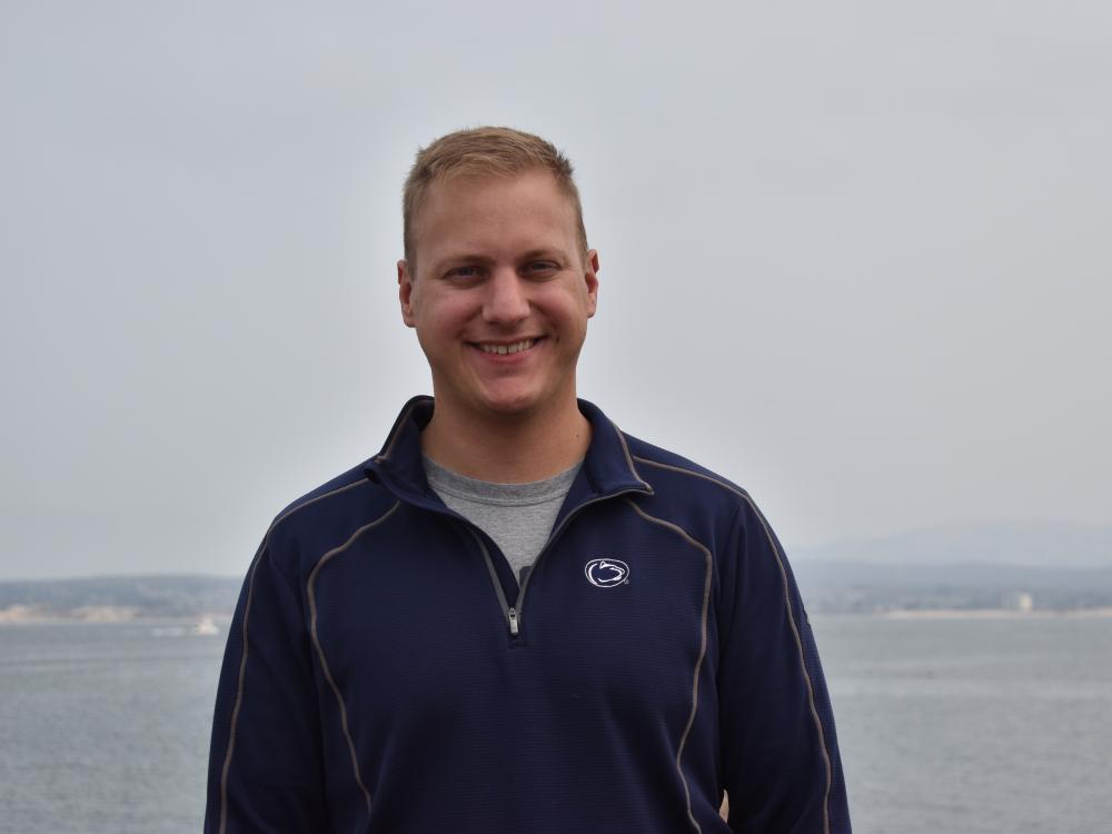 John McFarland stands in front of ocean