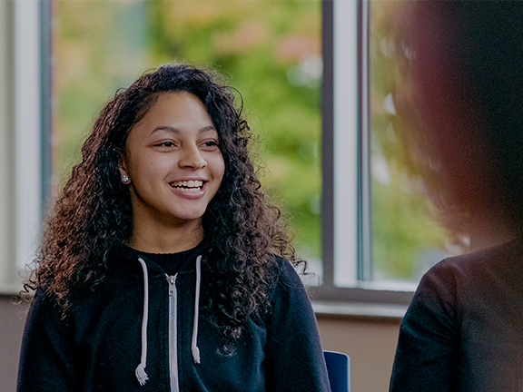 Photograph of young woman talking to adviser