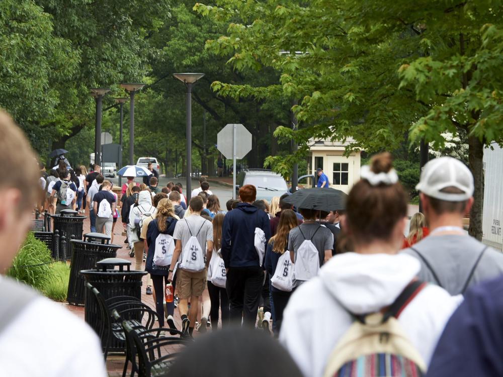 Students walking down a sidewalk during New Student Orientation