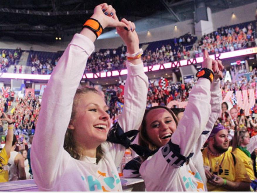 Scranton dancers Dana and Katie on the dance floor of the Bryce Jordan Center for THON, making a diamond sign with their hands.