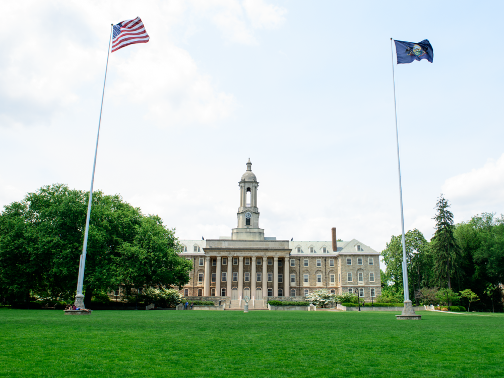 Long shot of Old Main and flags