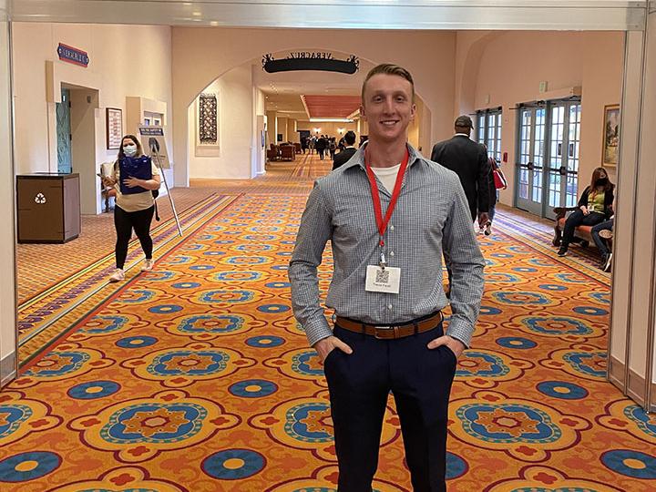Trevor Faust stands at veterans conference 