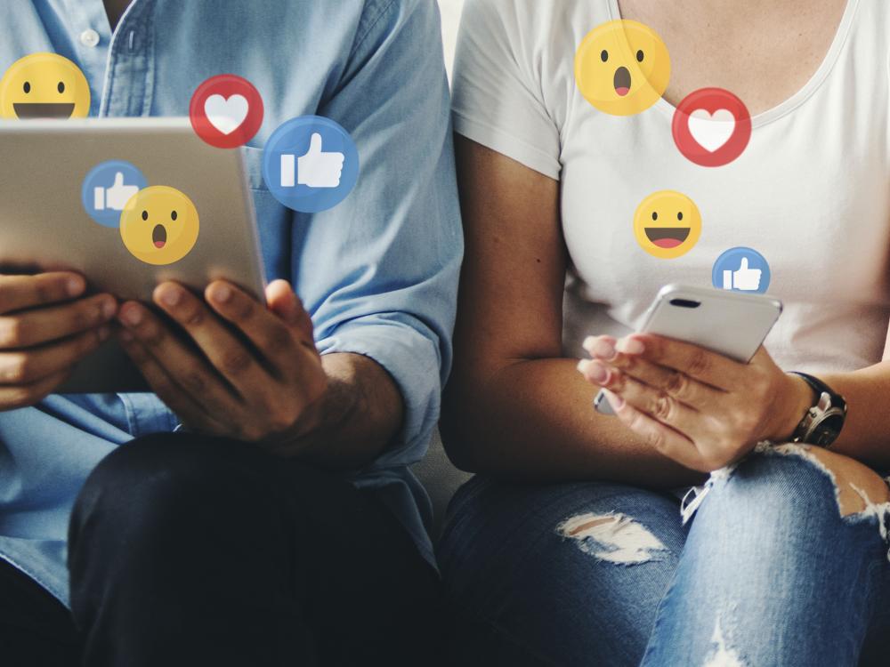 Two social media users monitor their content activity through engagement emojis