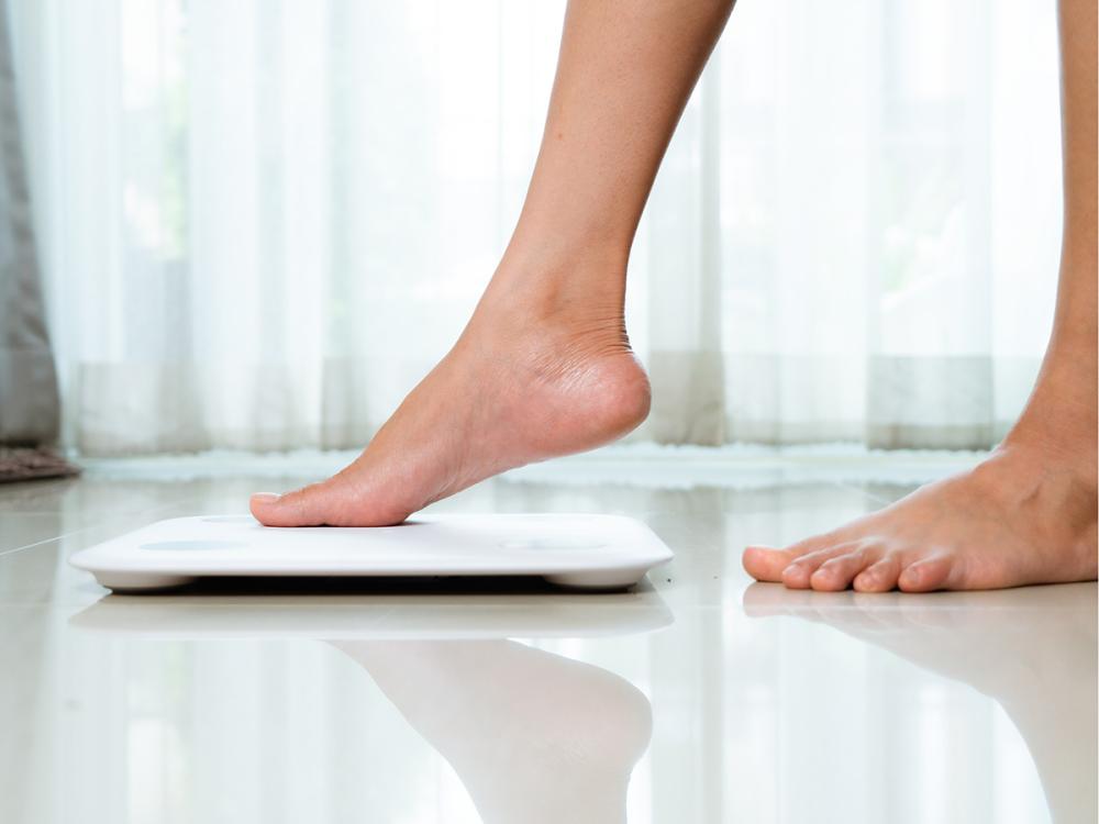 feet stepping onto a scale
