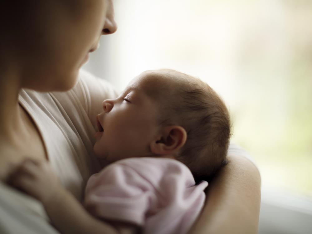 Woman holding infant in her arms