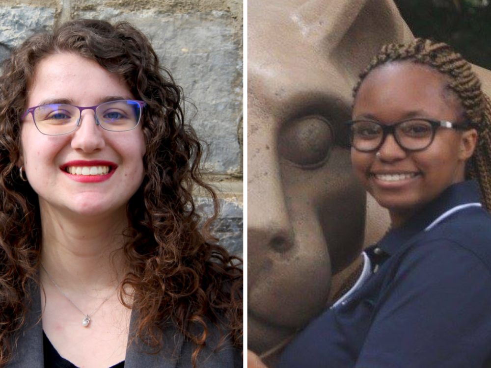 woman on left in front of Old Main window, woman on right in front of lion shrine statue