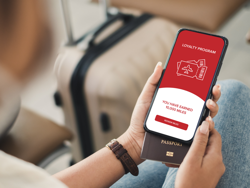 Woman looks at airline miles app on her smartphone