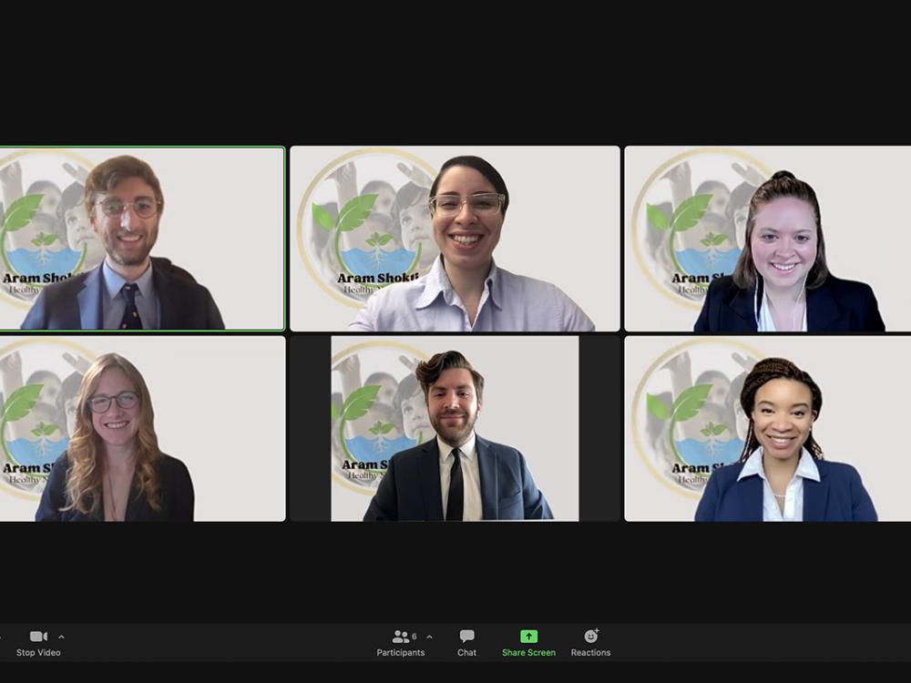 A screenshot of a Zoom meeting with six Penn State students, all wearing professional attire, smiling.