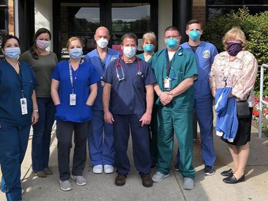 Healthcare professionals standing outside nursing home