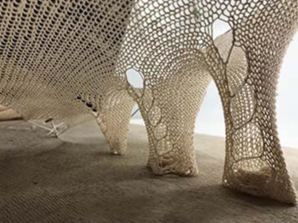 The base of the MycoKnit showing the yarn-knitted textiles on which mycelium-based composites will grow.