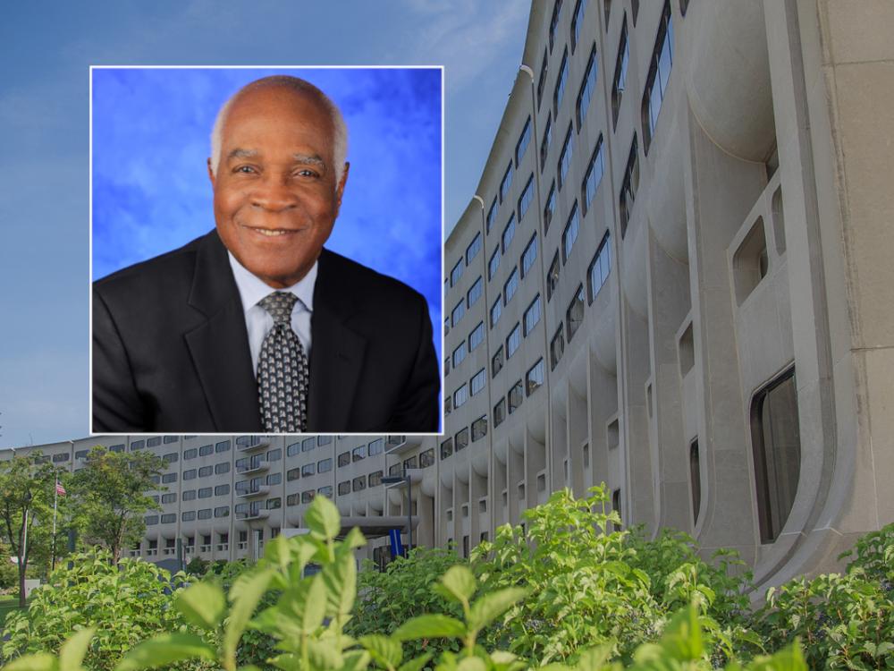 A headshot of Dr. Rodrigue Mortel placed over a photo of Penn State College of Medicine's "crescent" building.