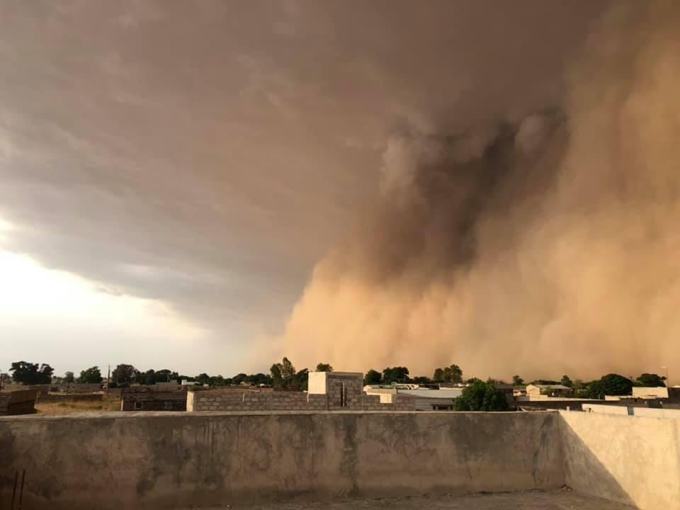 Village with large dust squall approaching