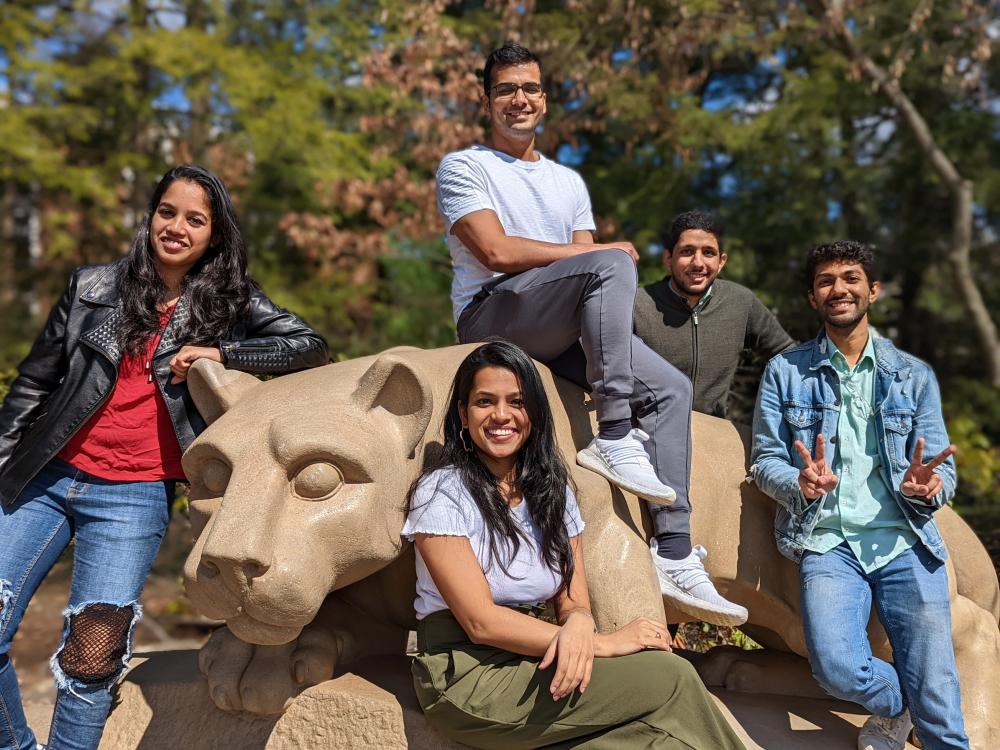 iLenz team members sitting in front of the Nittany Lion Shrine