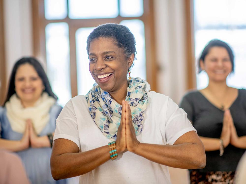 3 smiling women in yoga class