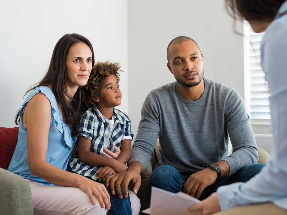 Parents and child talking with a counselor